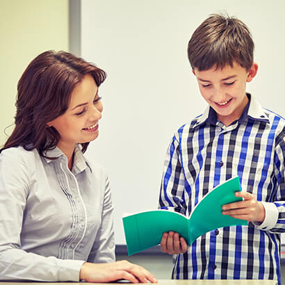 Student reading to his teacher